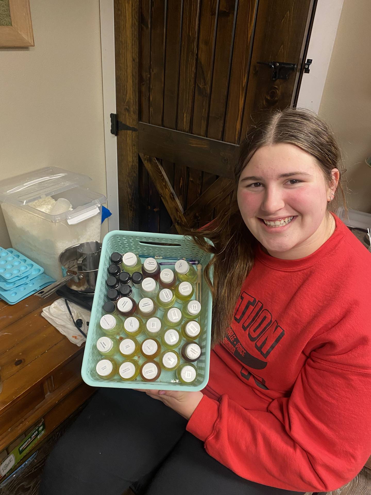 Sayde Hogg shows some of her soy wax candles that she makes along with car freshies for her Sayde’s Scents business.