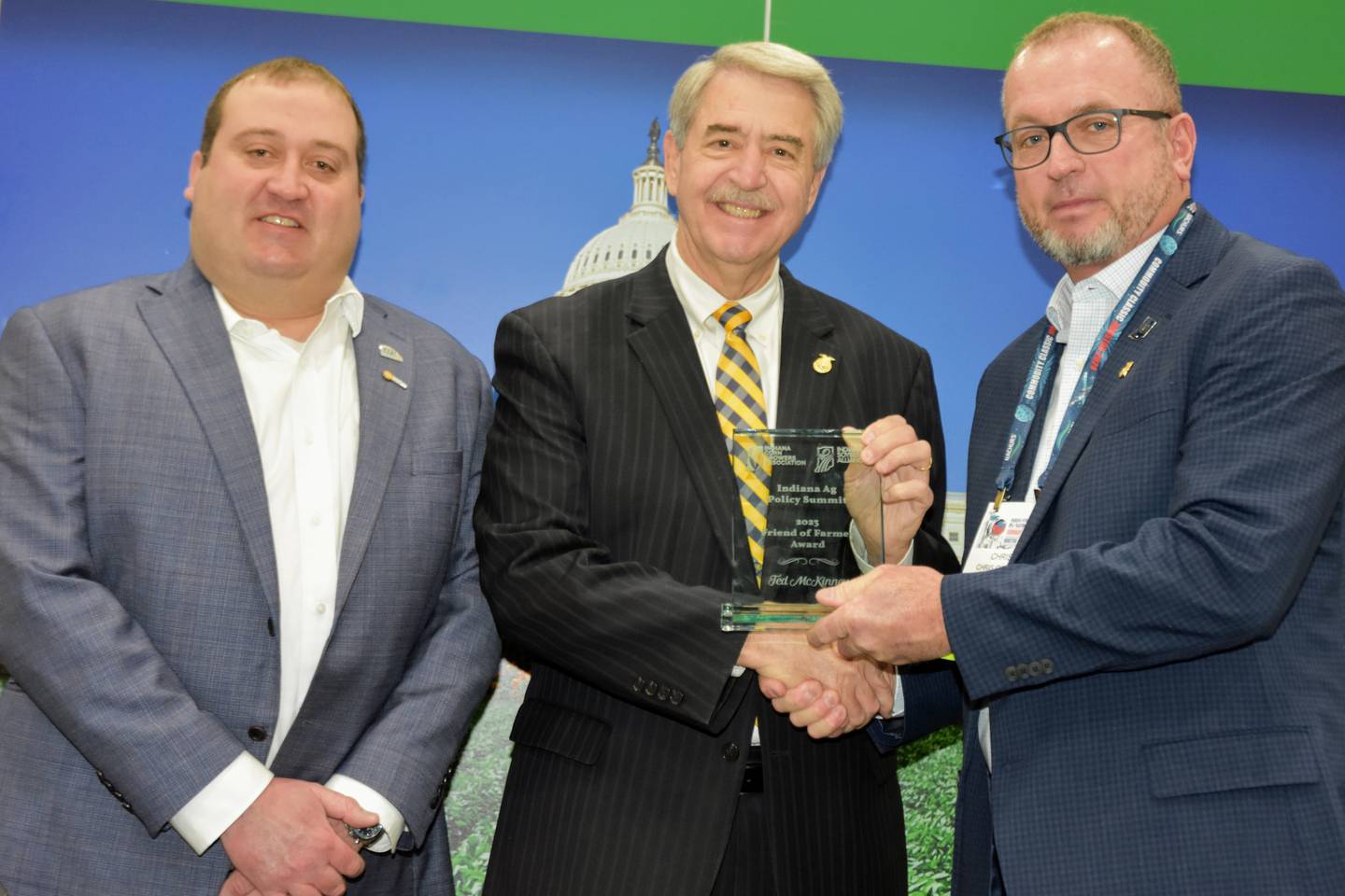 Ted McKinney, CEO of the National Association of State Departments of Agriculture, receives the Friend of Farmer award from Joe Stoller (left), Indiana Soybean Alliance Membership & Policy Committee chair, and Chris Cherry (right), Indiana Corn Growers Association president, at the Commodity Classic in Houston.