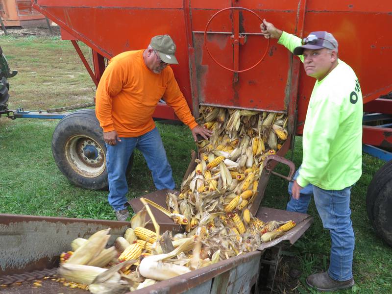 Joe (left) and Alan Smolkovich dump ear corn onto the portable elevator for a trip up to the top and into the crib on Oct. 24. After a delay to repair the picker, the Smolkovich brothers had just 20 acres of corn left to harvest.