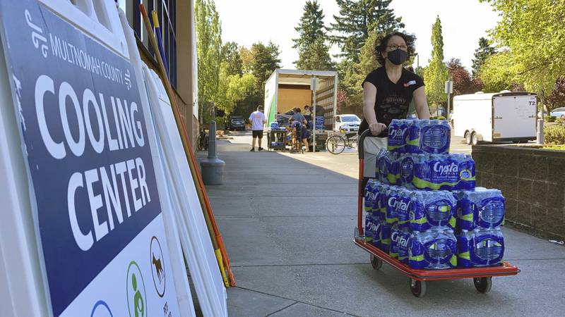 A volunteer helps set up snacks at a cooling center established to help vulnerable residents ride out the dangerous heat.