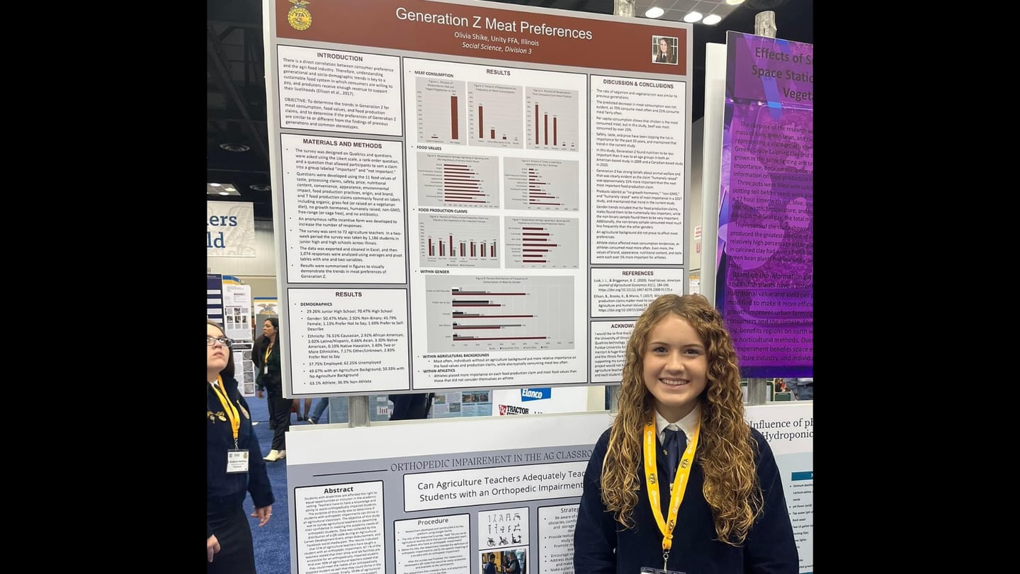 Olivia Shike stands by the poster of her project that included a survey of junior high and high school kids about Generation Z meat preferences.