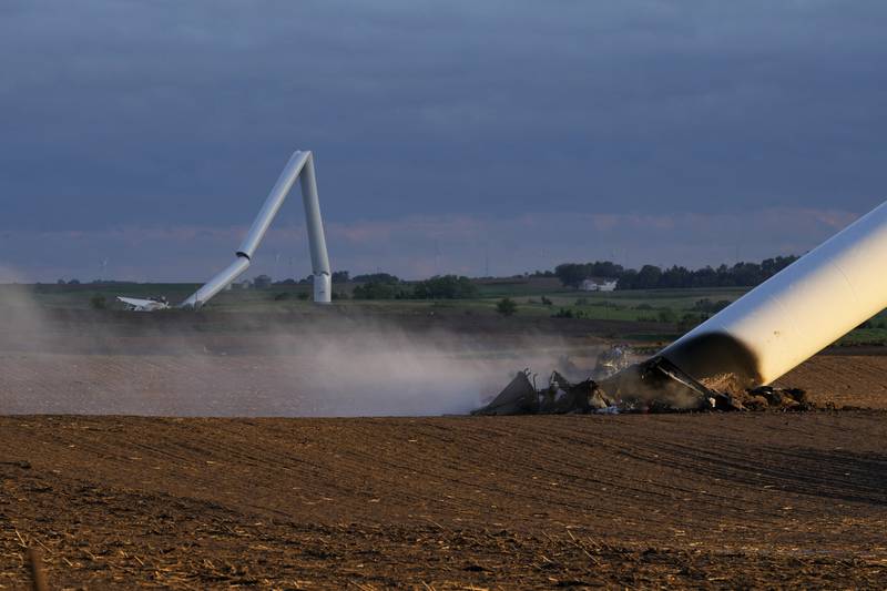 The remains of two tornado-damaged wind turbines touch the ground in a field May 21 near Prescott, Iowa.