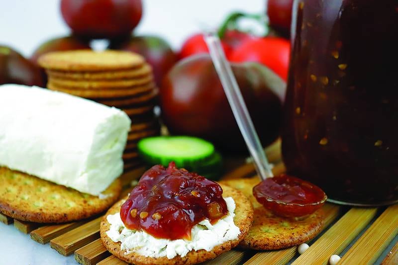 Homemade tomato jam, with creamy goat cheese and crackers, is savory, slightly sweet and completely addictive.