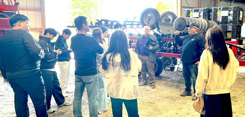 Jim Martin (second from right) provides insights into central Illinois agriculture production and spring planting to visitors from South Korea participating in Kansas State University’s International Grains Program. Guy Allen (third from right), senior economist for the IGP Institute at K-State, led the tour.