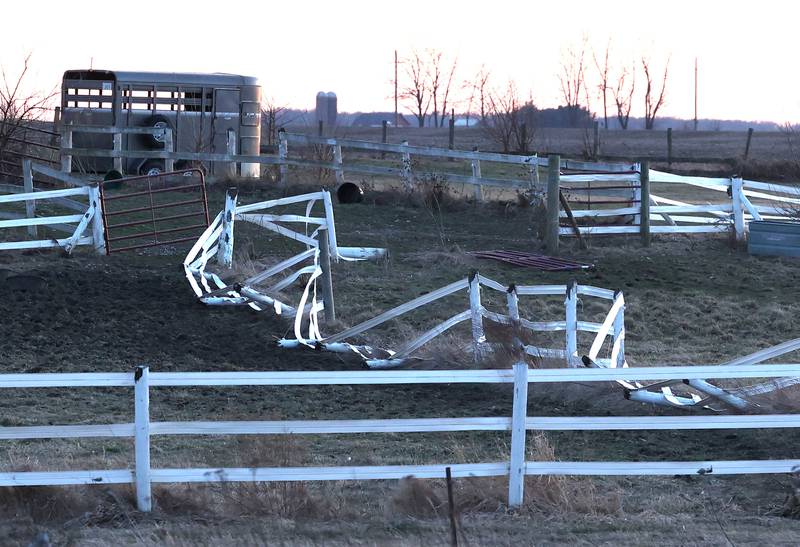 After a tornado hit the area on Feb. 27, a fence is damaged at a property along East Sandwich Road in Hinckley, Illinois.