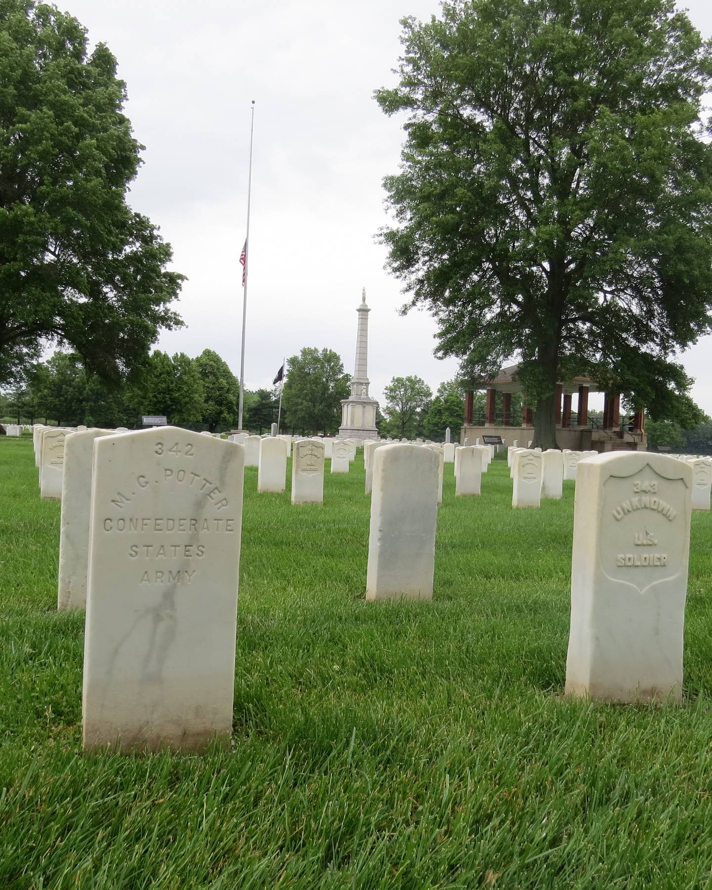 Two headstones tell a tale of war at Mound City National Cemetery. Union and Confederate soldiers are buried at the national cemetery in southern Illinois. Mound City served as a major transportation and hospital center for the western theater during the Civil War. The shipbuilding yard located on the Ohio River repaired and built Union gunboats that were used in battles along the Mississippi and Tennessee rivers. A large hospital, staffed by the Sisters of the Holy Cross, from South Bend, Indiana, cared for wounded at a large hospital and on board the Red Rover, a Union hospital boat that brought wounded from battles to the military hospital at Mound City, Illinois. Those wounded included Confederate prisoners of war. Around 47 Confederate prisoners of war who died at the Mound City military hospital are buried in the national cemetery.