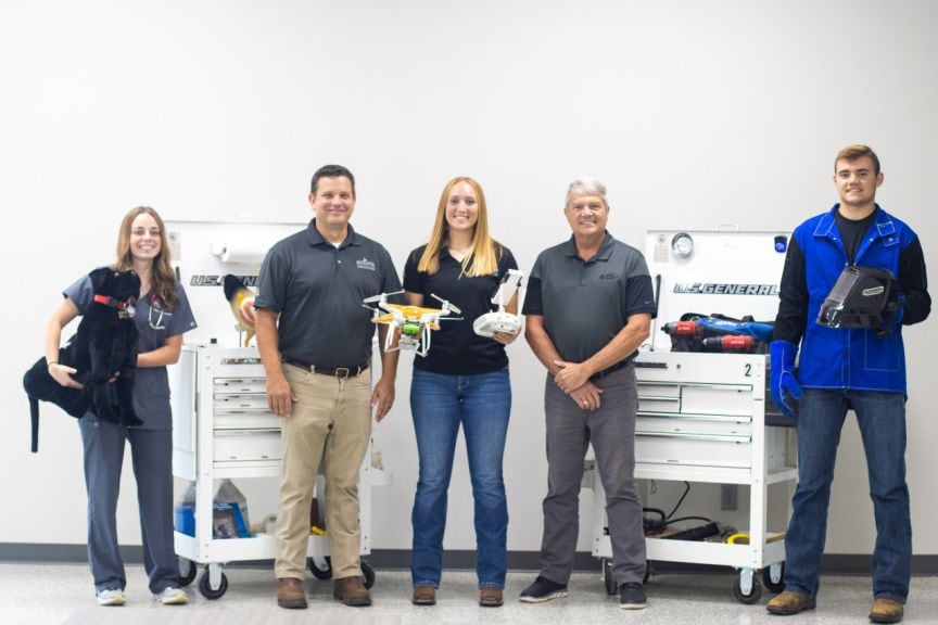 Sydney Petersen (from left), an animal health and veterinary nursing student from Indiana; Nate Perry, managing director of the Haupert Institute for Agricultural Studies; Courtney Mason, an agribusiness student from Michigan; Kevin Johnston, former government and community relations manager at Duke Energy; and Wyatt Harrington, an agricultural education student from New York, present some of the equipment purchased through the grants Huntington University received from the Duke Energy Foundation.