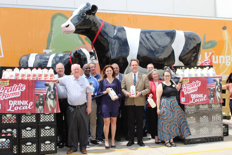 Representatives of groups involved with donating over 34,000 servings of milk gather along with those from the Northern Illinois Food Bank and the Geneva Mayor Kevin Burns (fourth from right) to celebrate the special event during National Dairy Month.