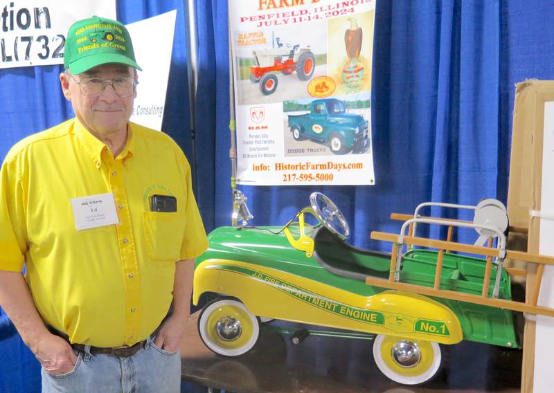 Ed Winkelman, Friends of Green Club president, stands next to the John Deere pedal fire truck that’s one of two prizes in the group’s drawing to raise scholarship funds for students in the Lake Land College Ag Tech program.