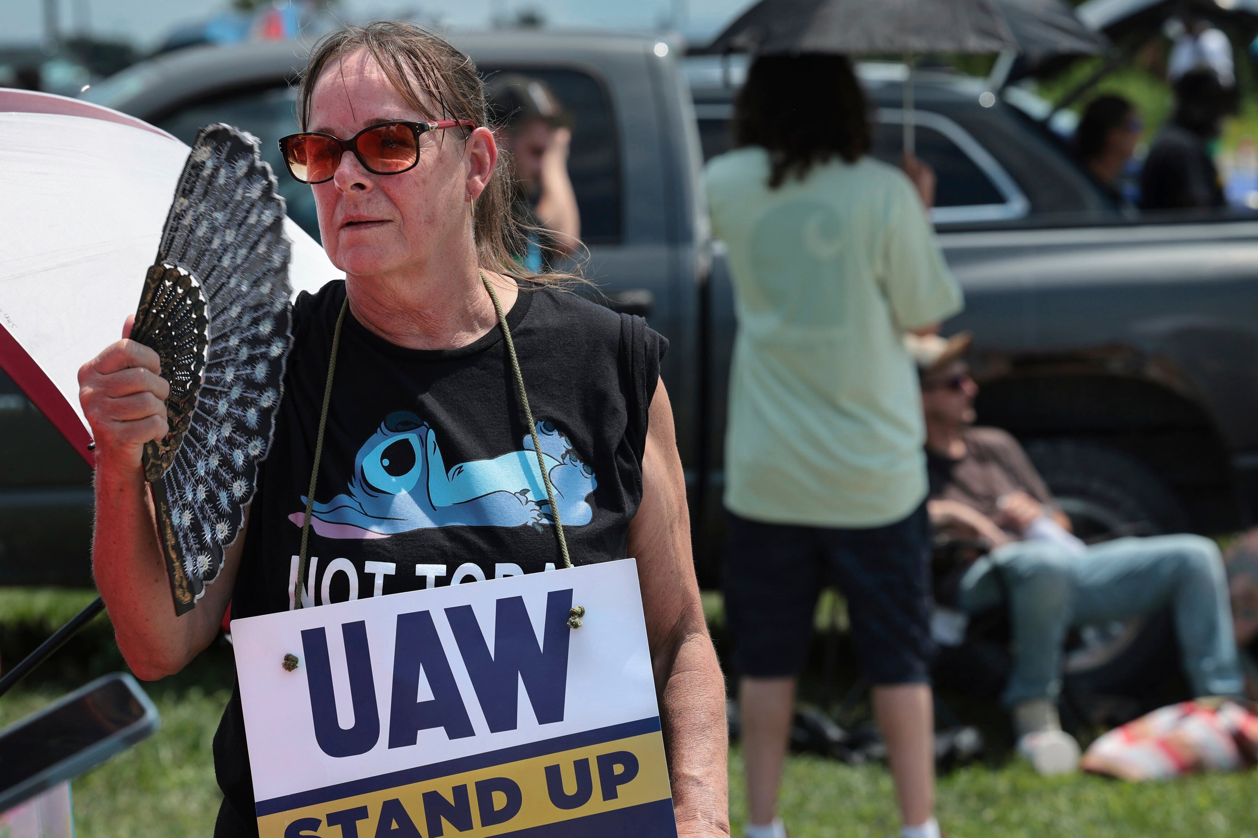 Assembly line worker Sheila Buckley tries to keep cool while on the picket line as members of United Auto Workers Local 282 are on strike against Lear, a car and truck seat manufacturer in Wentzville, Missouri. The strike led to a shutdown at the nearby GM assembly plant.