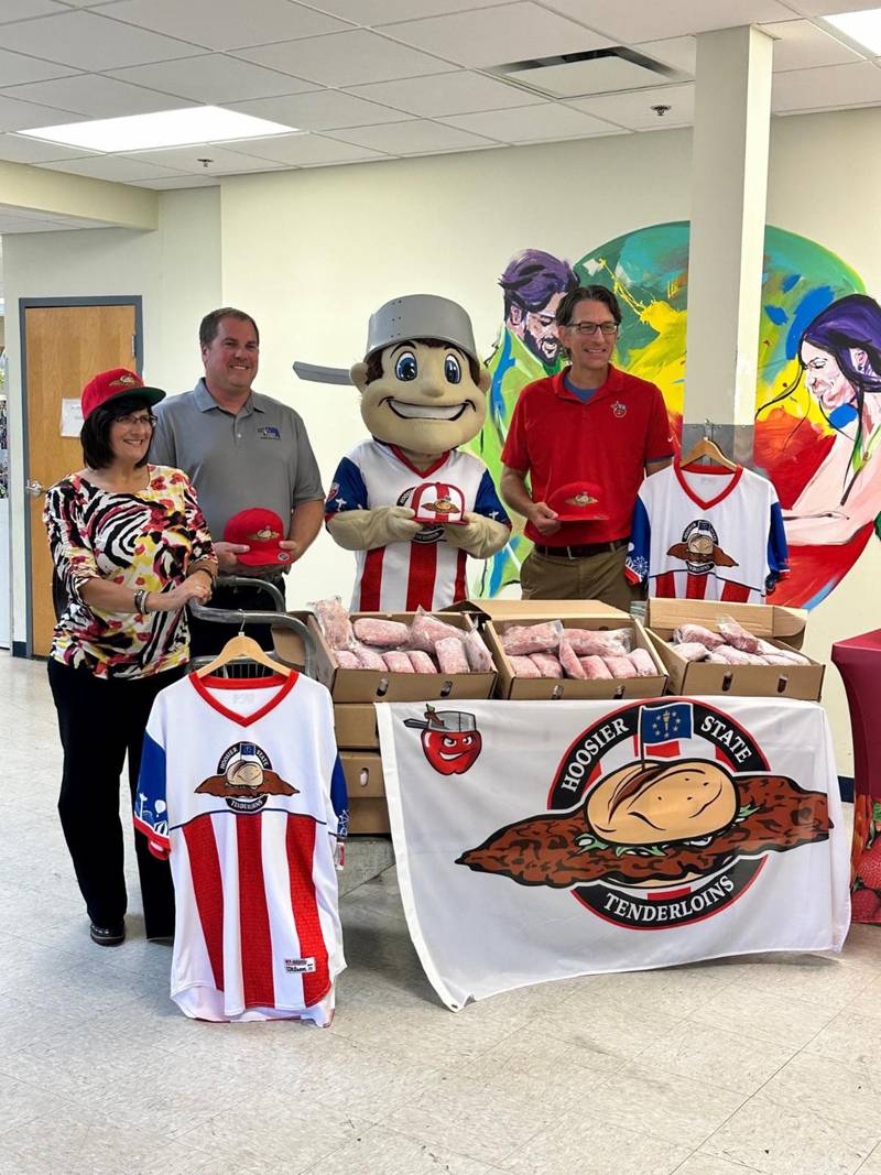 Carmen Cumberland (from left), Community Harvest president and CEO; Mark Johnson, Indiana Pork board of directors and Whitley County pig farmer; Mascot Johnny TinCap; and Michael Limmer, Fort Wayne TinCaps vice president of marketing.