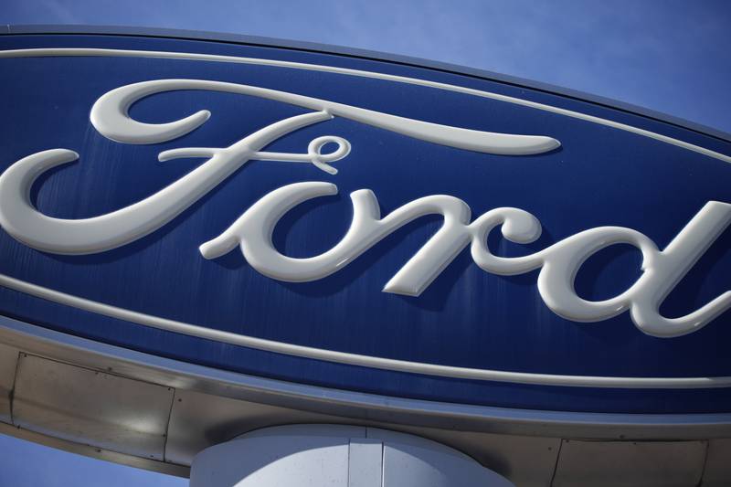 A Ford company logo on a sign at a Ford dealership in southeast Denver.