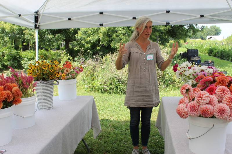 Anna Guziak-Prochnicka talks about the flowers she harvested from her Gold Fern Farm during a Women Caring for the Land Learning Circle event. In addition to selling cut flowers and bouquets at farmers market, the farmer also sells Dahlia tubers.