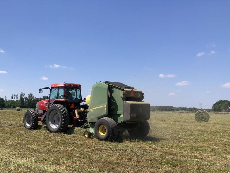 The Geyer family bales alfalfa on their farm in northern Indiana.