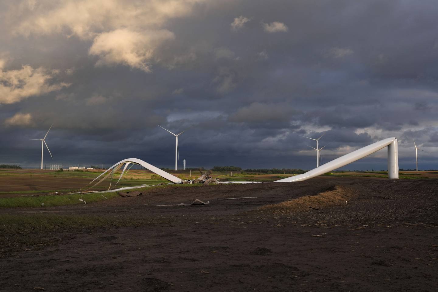 The remains of a tornado-damaged wind turbine touch the ground in a field May 21 near Prescott, Iowa.