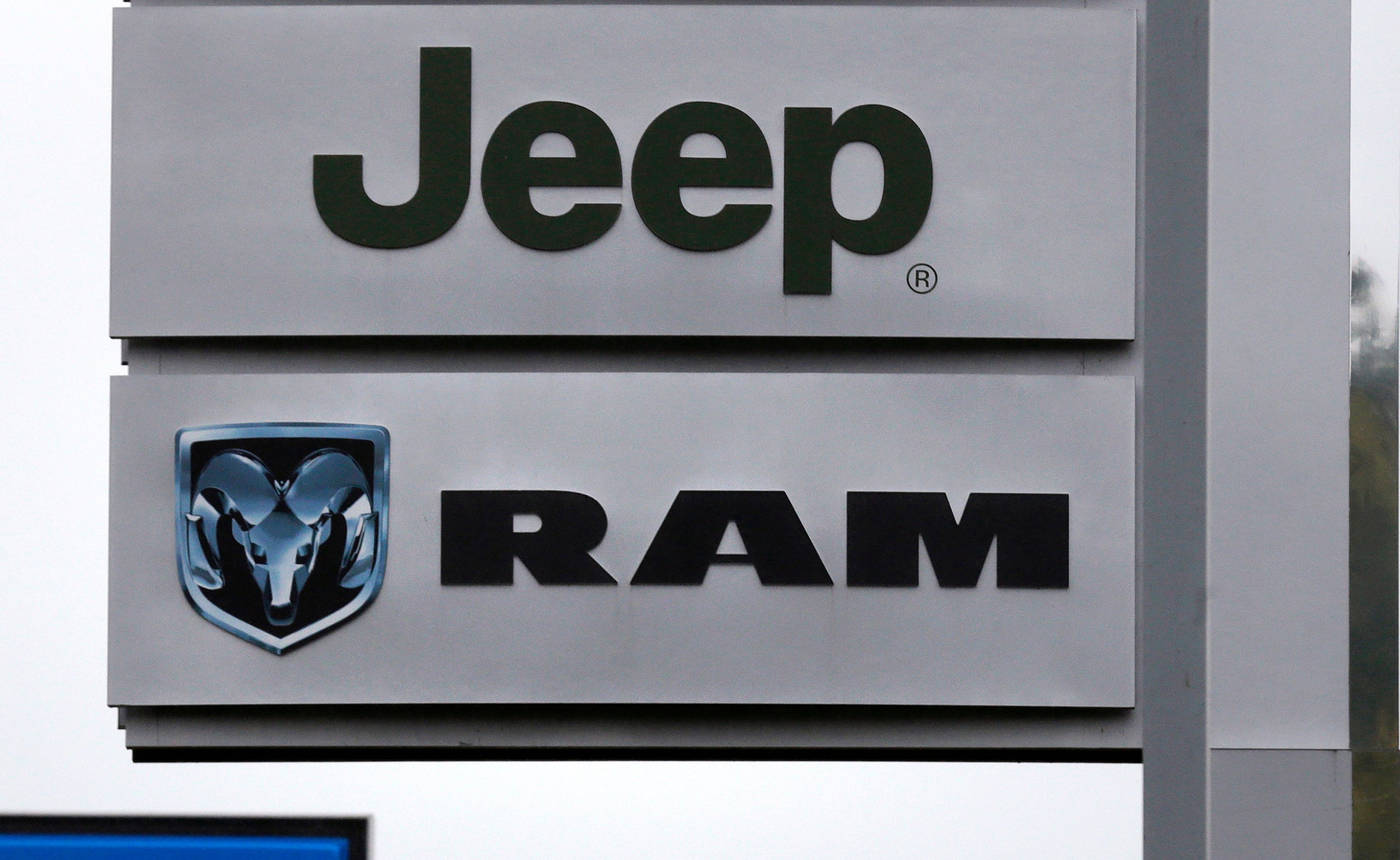 This photo shows Jeep and Dodge Ram logos on signs at a dealership in Haverhill, Massachusetts.