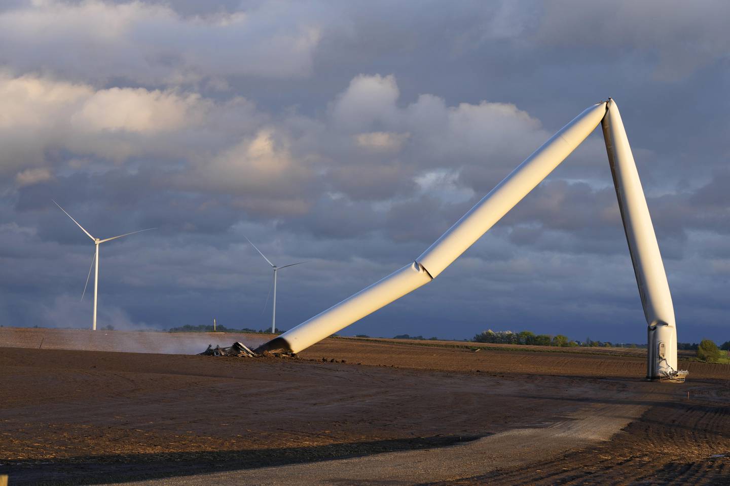 The remains of a tornado-damaged wind turbine touch the ground in a field May 21 near Prescott, Iowa.