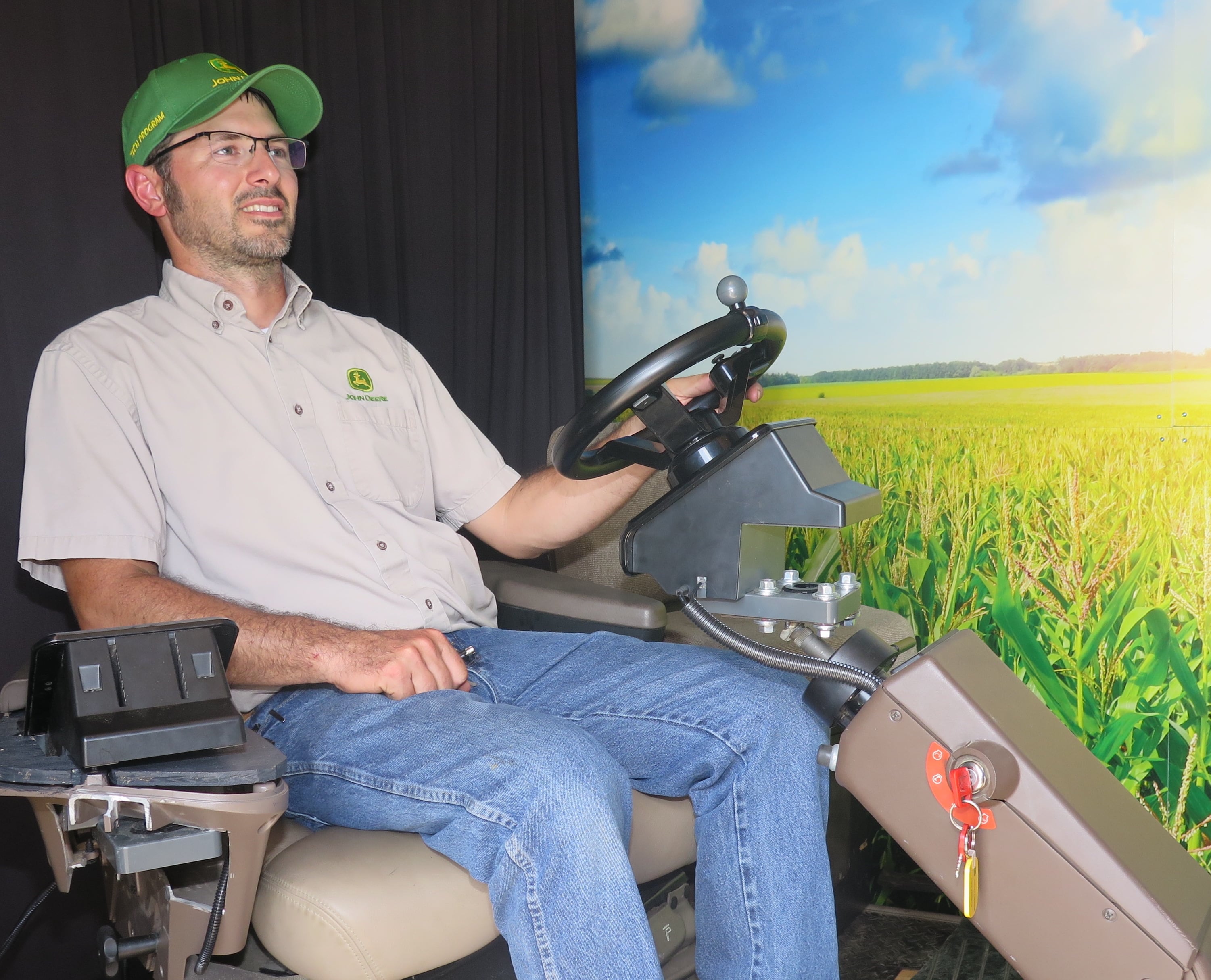 Russell Neu, Lake Land College’s John Deere technology program coordinator, demonstrates the mobile simulator at Historic Farm Days. Visitors could be in the driver’s seat to maneuver a myriad of John Deere equipment.