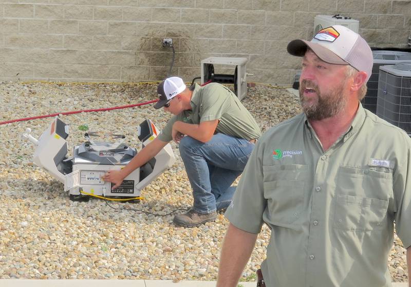 Jason Webster, Precision Technology Institute director and Precision Planting commercial agronomist, details the possibilities with a new all-in-one drone system for scouting fields as Kaden Brackman, PTI intern, readies the UAV for a demonstration.