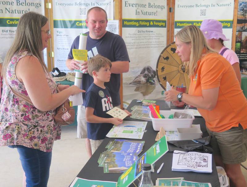 A youngster gets his Everyone Belongs in Nature Passport stamped at the Illinois Department of Natural Resources tent during the state fair. The displays promoted the numerous opportunities throughout the state to enjoy nature.