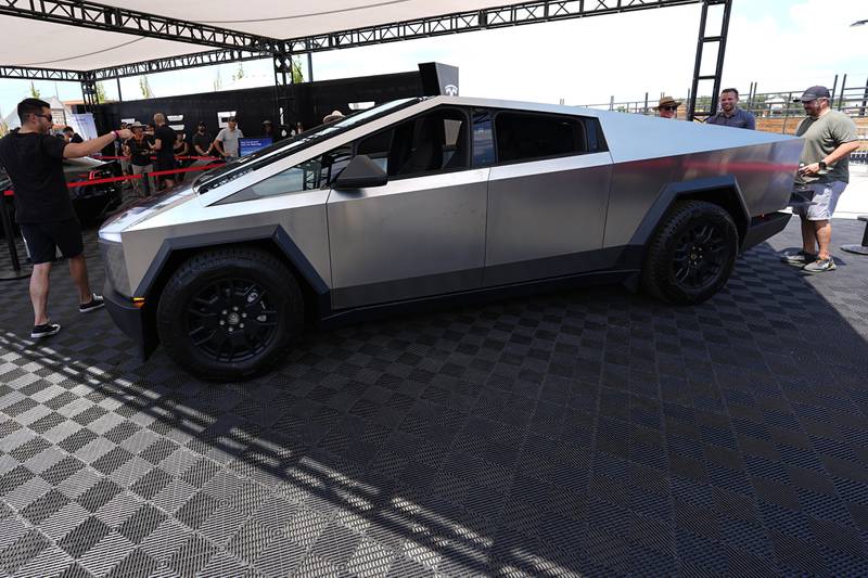 Visitors look over a 2024 Cybertruck in the Tesla display at the Electrify Expo, July 14, 2024, in north Denver. (